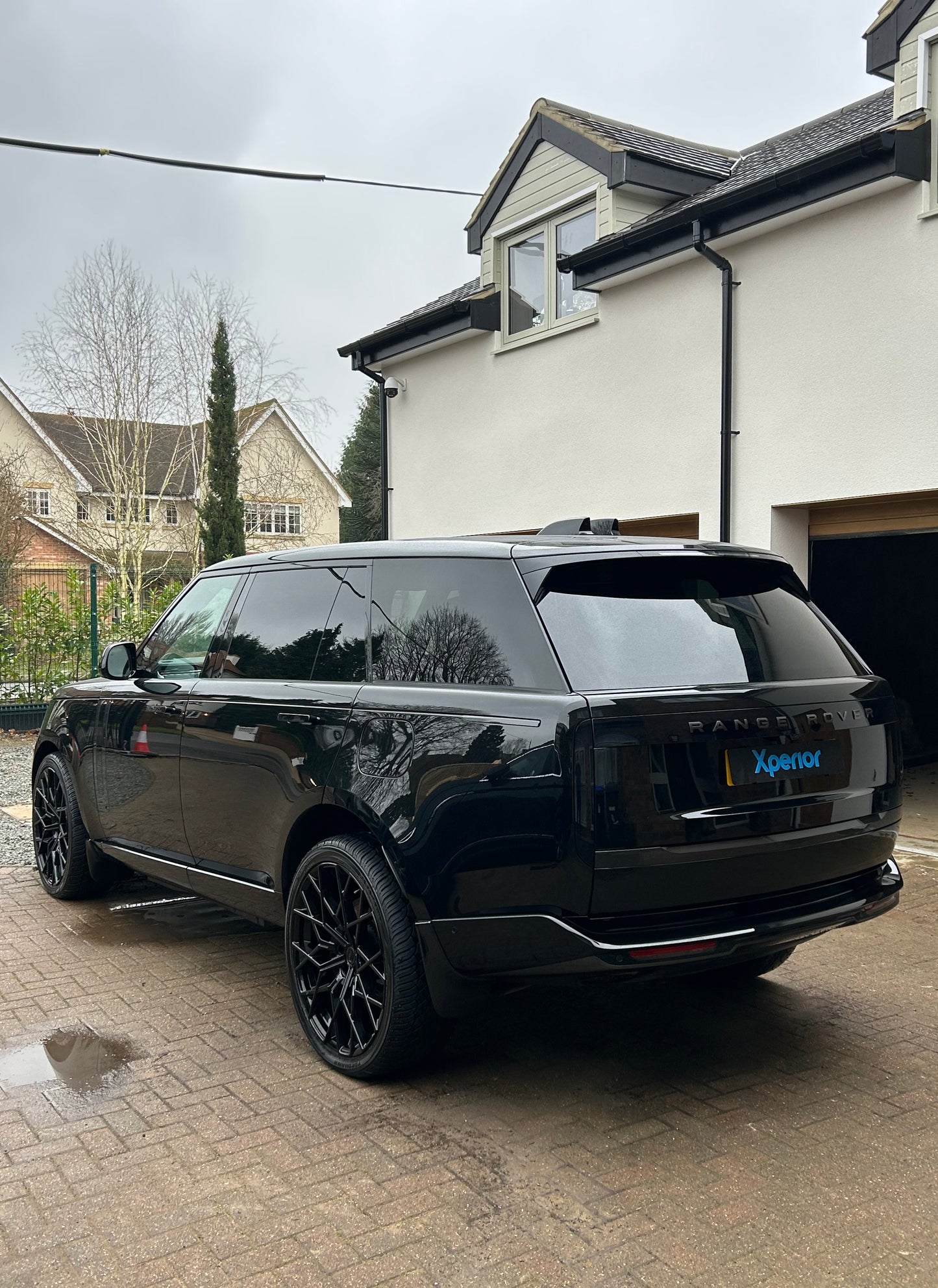 Rear view of a brand-new blacked-out Range Rover with Urban wheels, showcasing its stunning exterior after a full deep clean service by Xperior Detailing in Northamptonshire