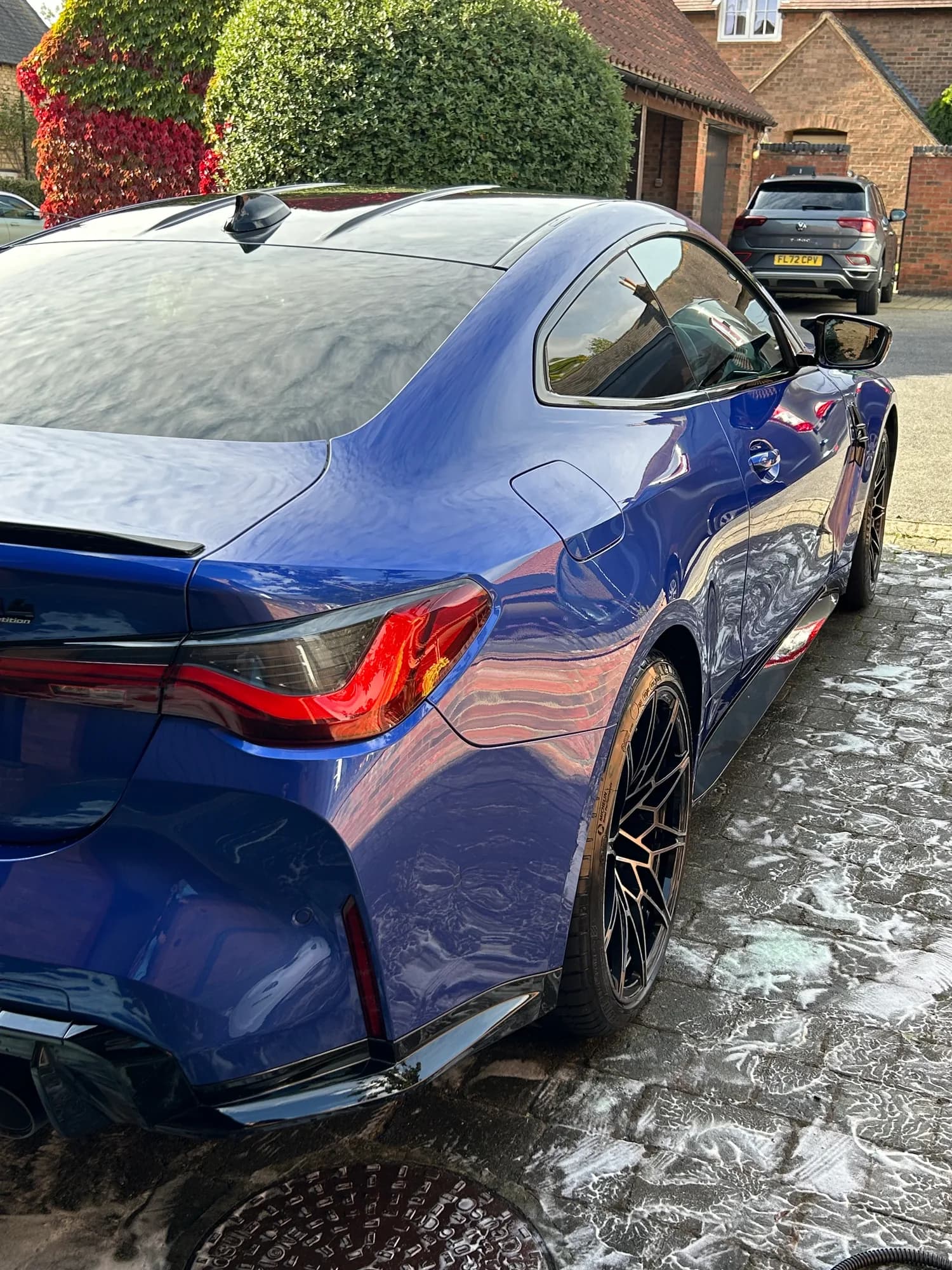 Water beading on the rear quarter of a ceramic-coated BMW M4