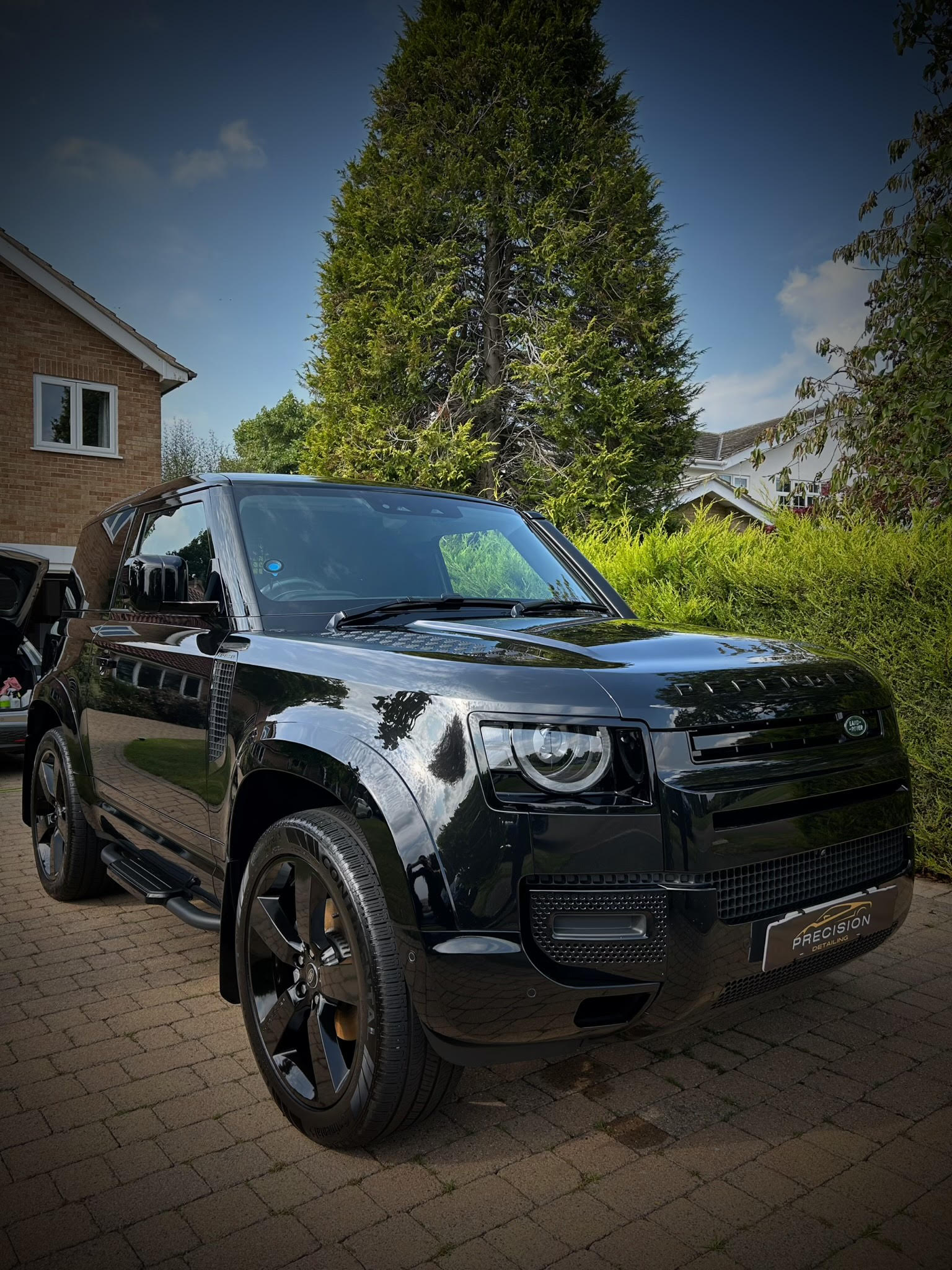 black glossy car, front view near side, looks brand new, car detailing