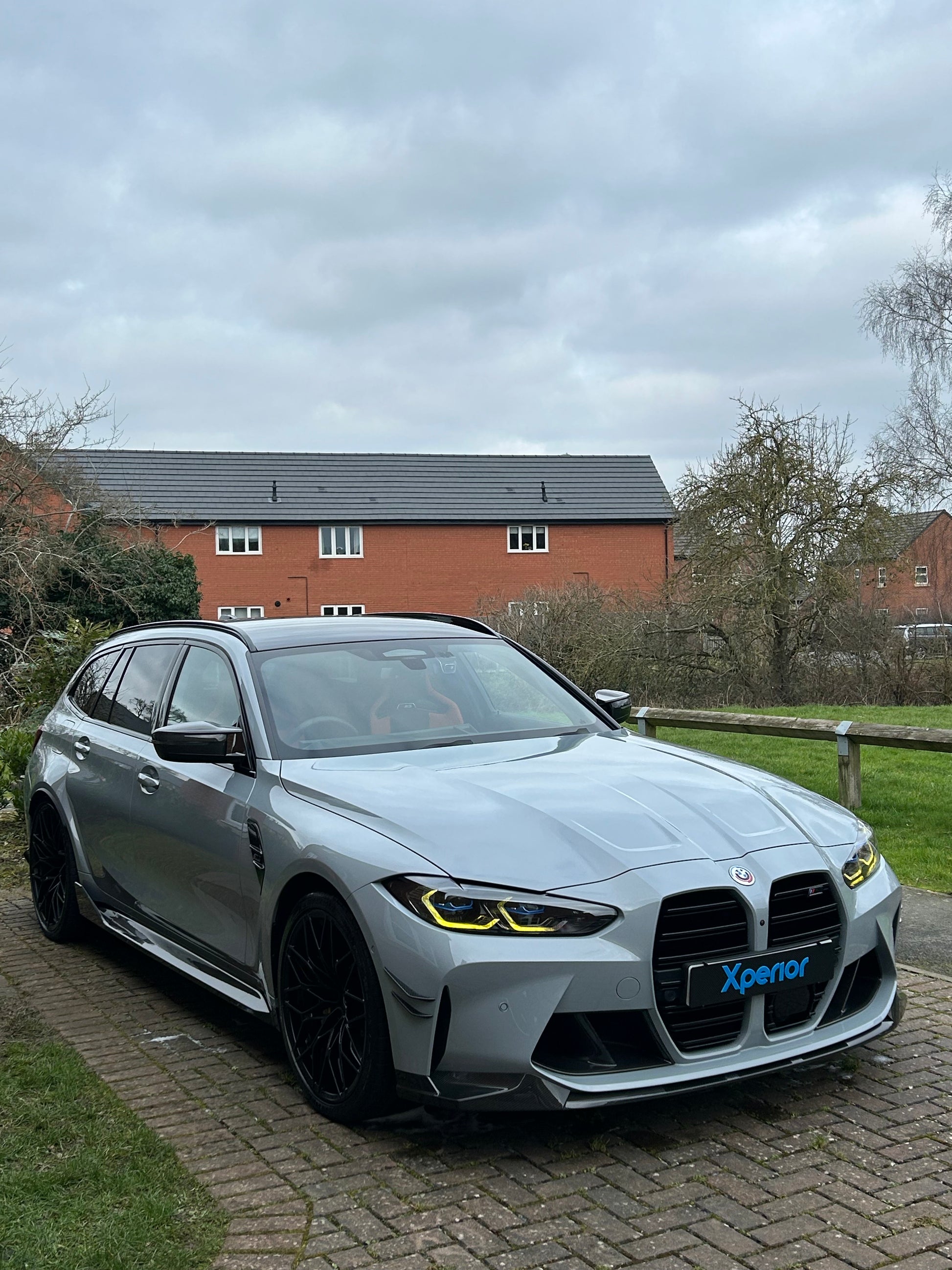 Glossy BMW M3 Touring from the front, straight after it has been detailed and maintained