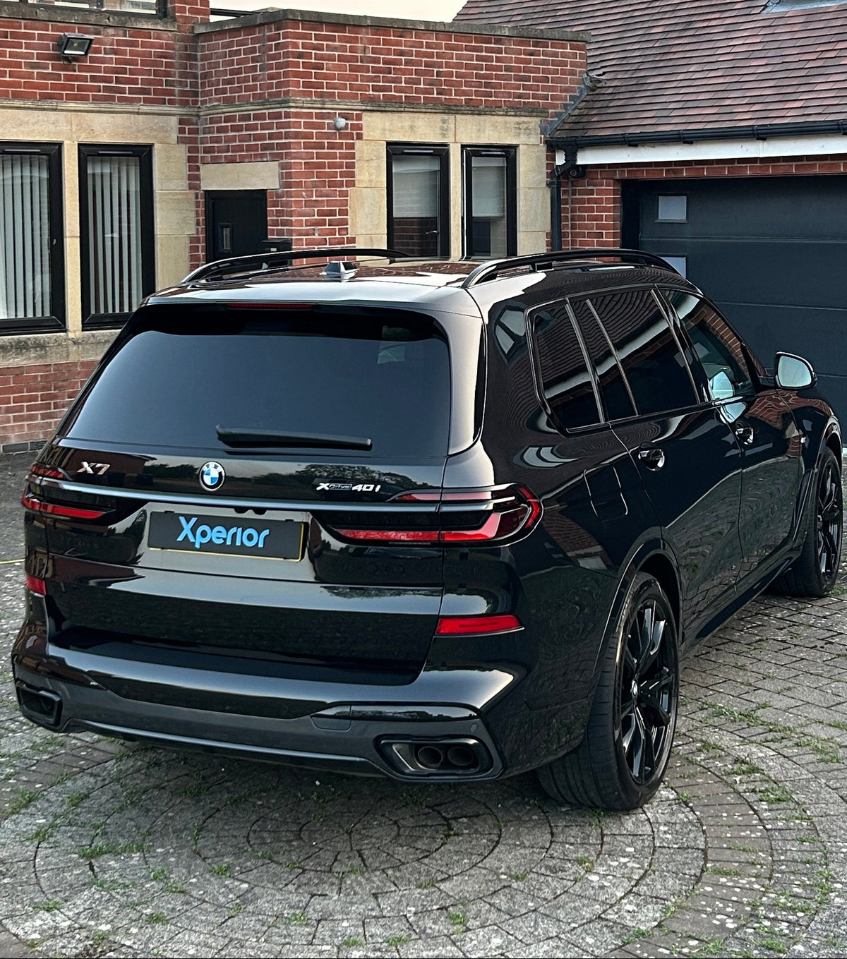 BMW X7 SUV with glossy black paintwork after a deep clean