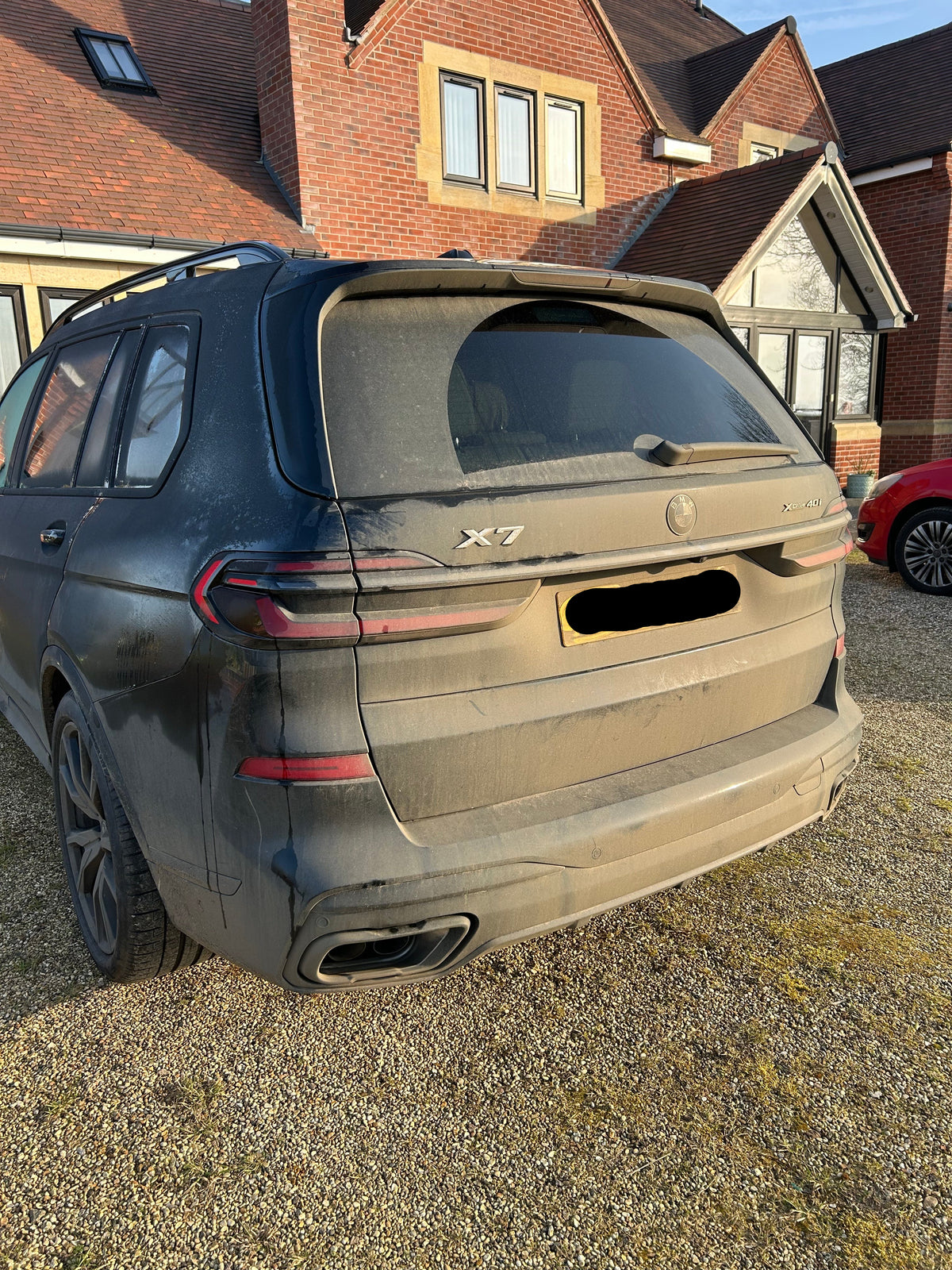 BMW X7 with grime on the rear before a deep clean