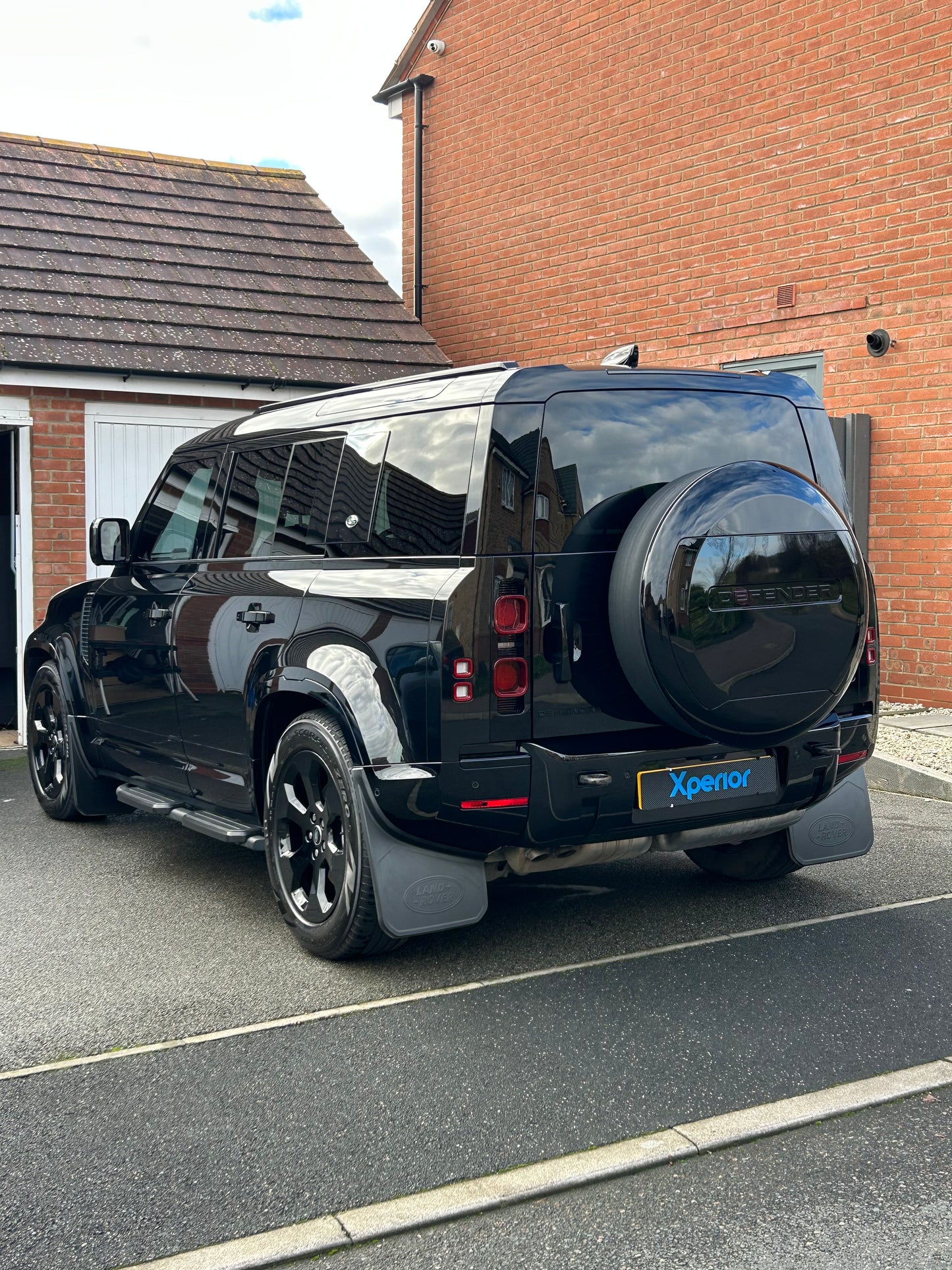Black Landrover Defender looking glossy after a one step paint correction mobile car detailing