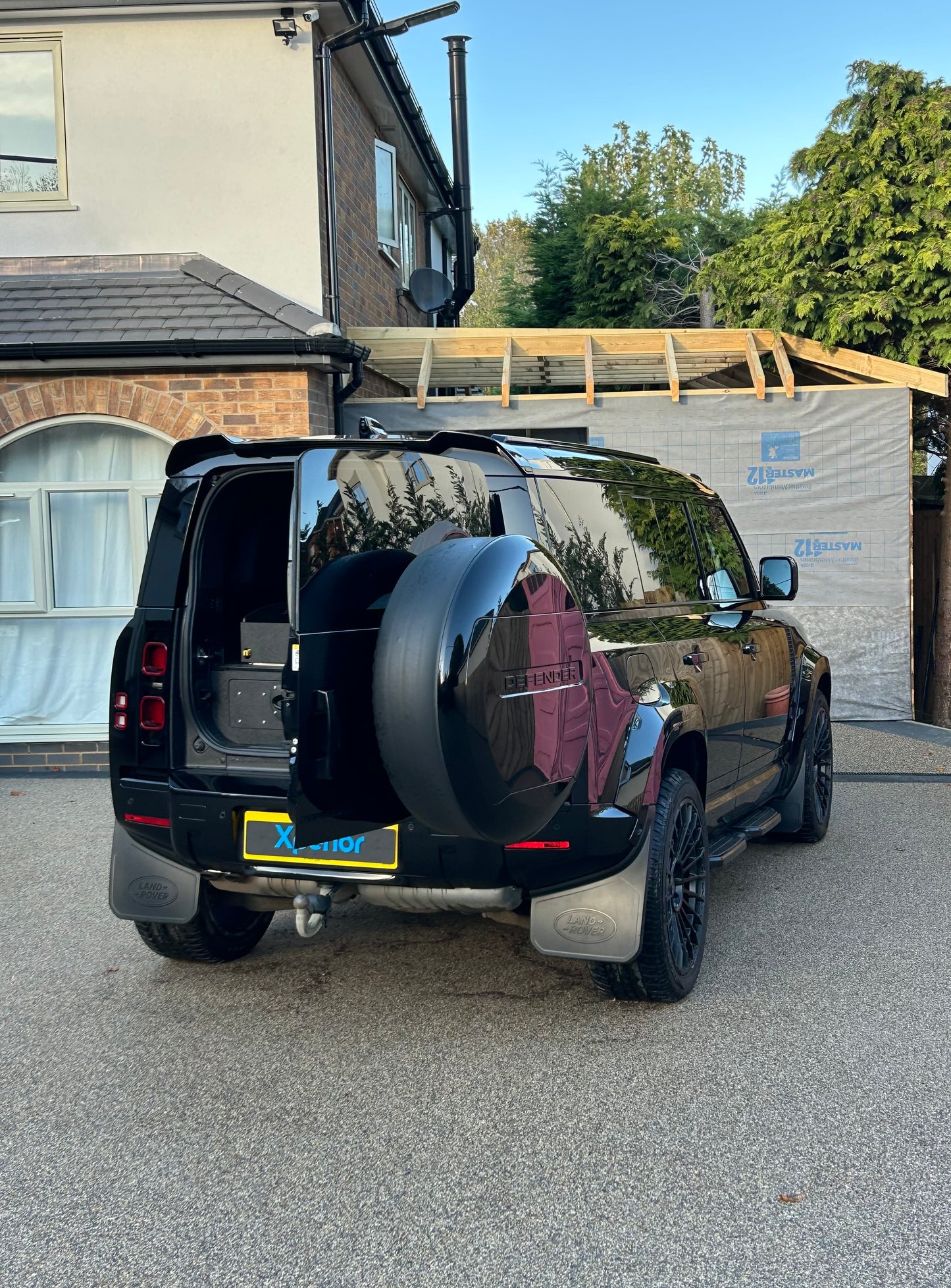 Glossy Land Rover Defender with Urban Body kit after mobile detailing and valeting