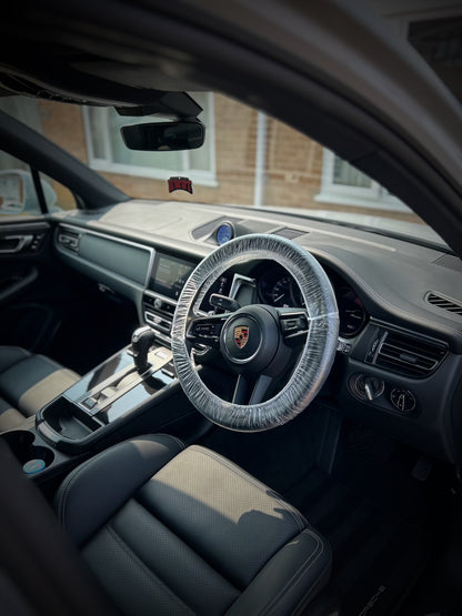 Porsche, interior driver side from the right, steering wheel in leather and console and dashboard on left, leather seat