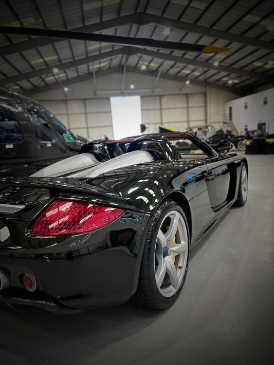 very glossy paint on car, side back view of porsche carrera gt, freshly cleaned