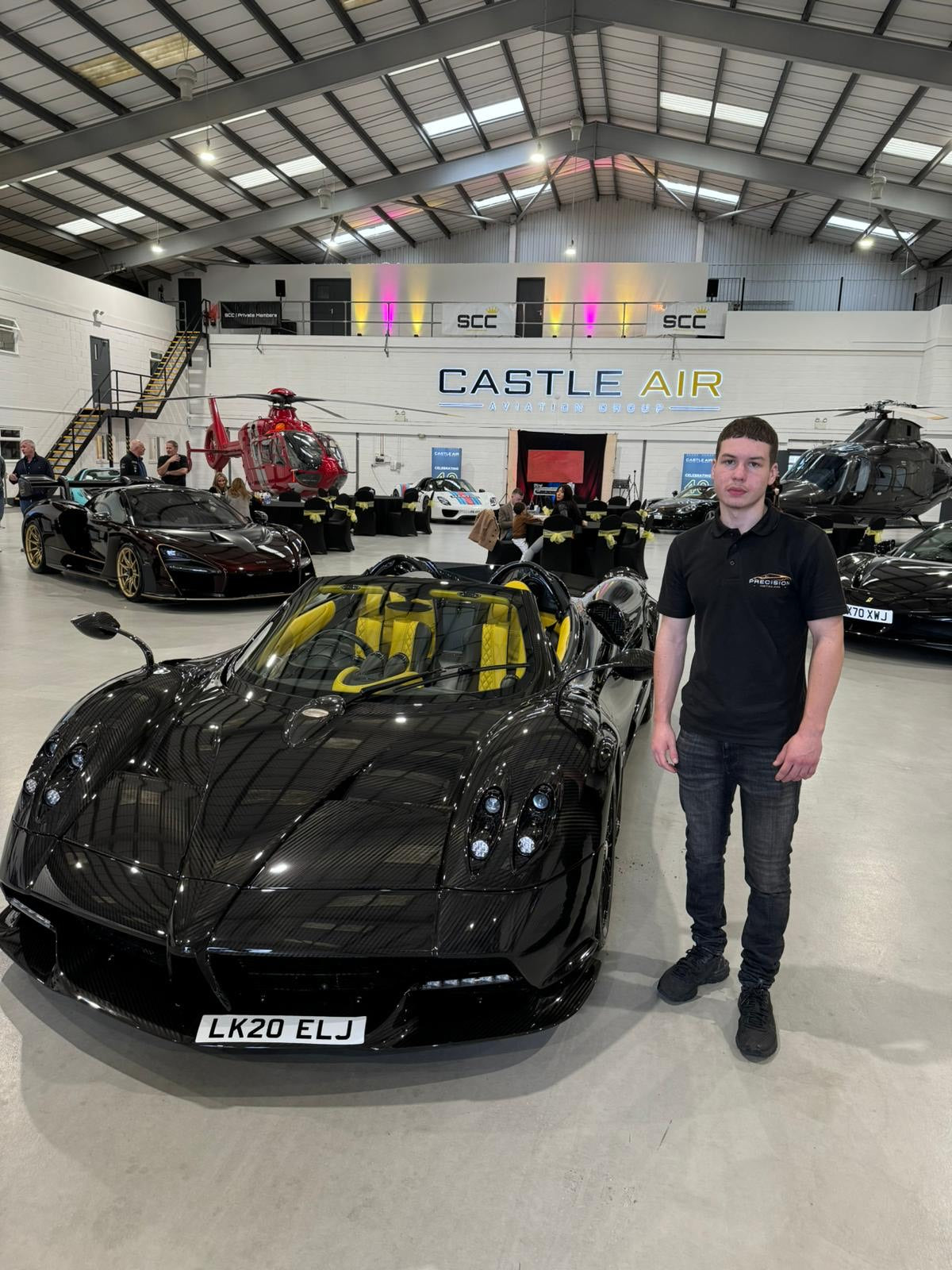 Hypercar detailing for a pagani huayra and standing next to it from the front